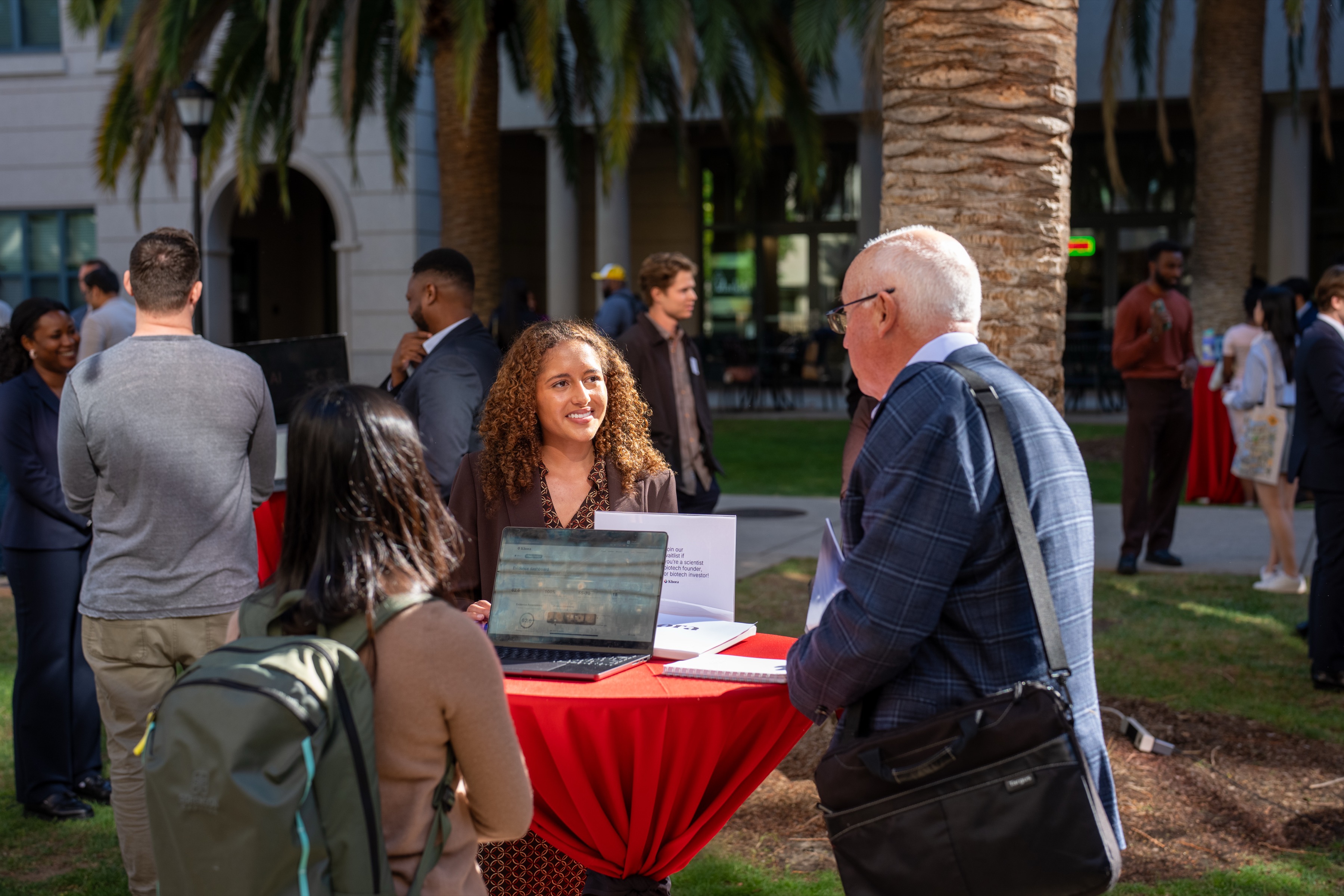 Gabrielle DeCuir speaking with an attendee at the Stanford Breakthrough Demo Day